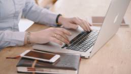 woman typing on laptop